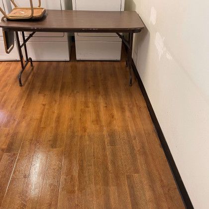 A folding table with a chair on top of it in a laundry room.