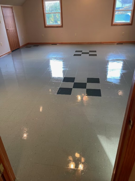 A room with a checkered floor and a window.