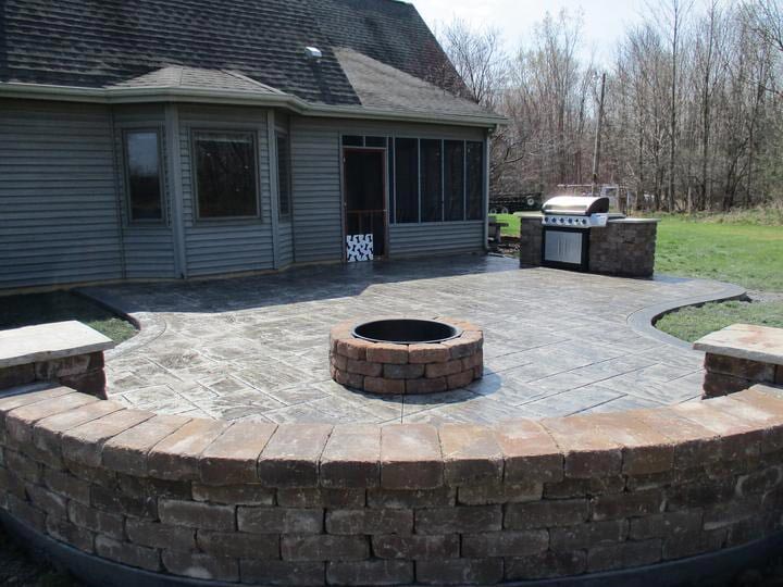 A fire pit in the middle of a customized patio