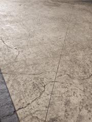 A close-up of a concrete floor with a gray border