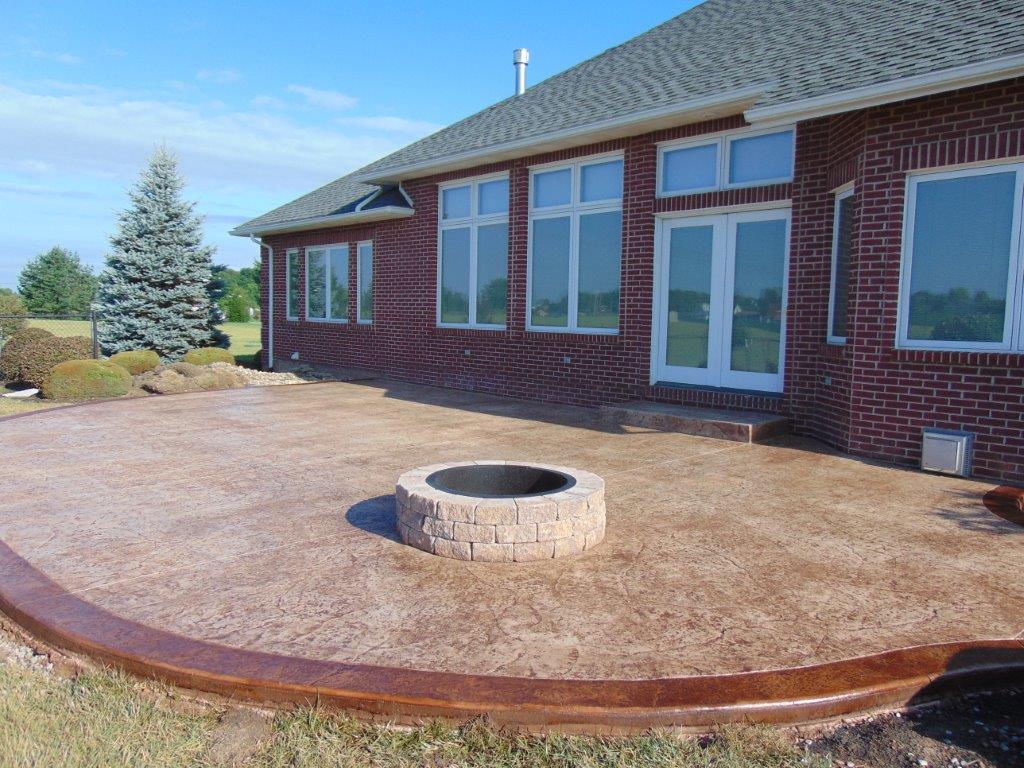 A brick house with a fire pit in front of it