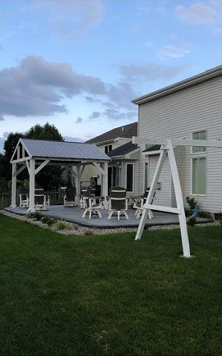 There is a swing set in the backyard of a house