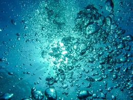 The sun is shining through the bubbles in the water