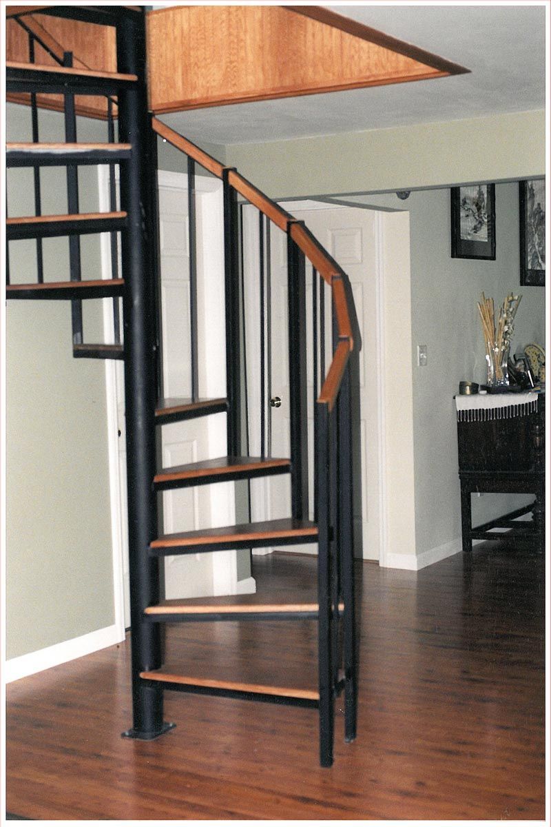 A spiral staircase with wooden steps in a living room