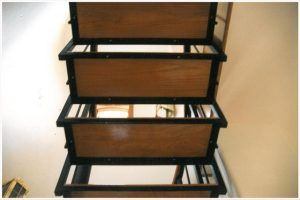 A set of wooden stairs with a metal frame