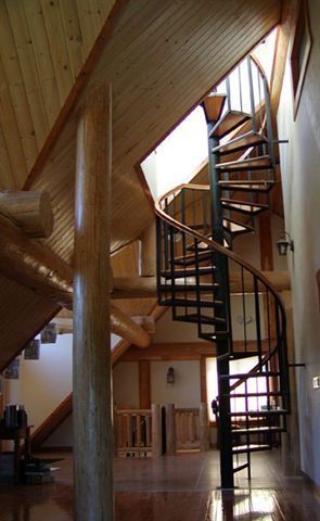 There is a spiral staircase in the middle of the room.