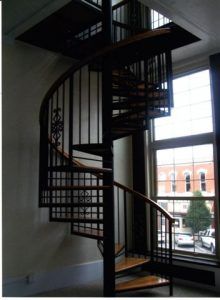 A spiral staircase in a room with a window