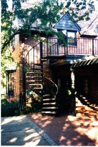 A house with a spiral staircase leading up to the second floor