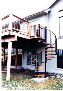 A house with a spiral staircase on the side of it