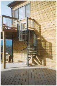 A wooden house with a spiral staircase on the side