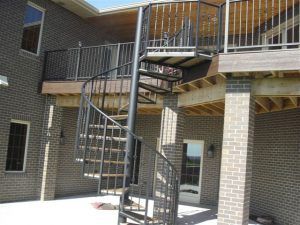 There is a spiral staircase leading up to the second floor of a house.