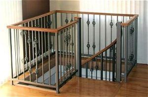 A staircase with a wrought iron railing and wooden handrails.