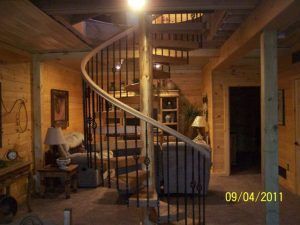 A picture of a living room with a spiral staircase taken on 09/04/2011