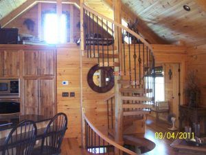 A picture of a wooden house with a spiral staircase