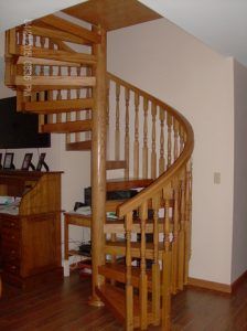 A wooden spiral staircase in a living room