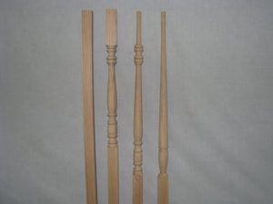 A group of wooden poles are sitting next to each other on a white surface.