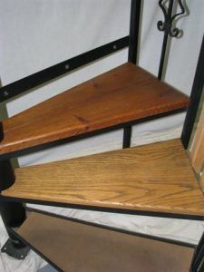 A spiral staircase with wooden steps and a metal frame
