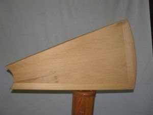 A piece of wood is sitting on top of a wooden pole.