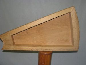 A piece of wood is sitting on top of a wooden pole.