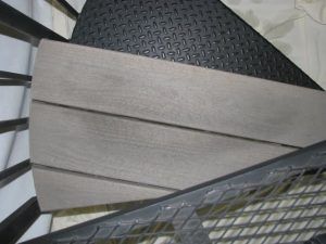 A close up of a spiral staircase with wooden steps