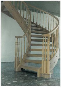 A wooden spiral staircase with a curved railing