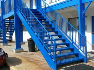 A set of blue stairs leading up to a building