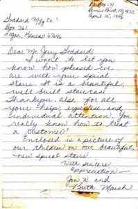A letter is written in cursive on a piece of paper