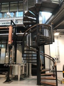 There is a spiral staircase in the middle of a building.