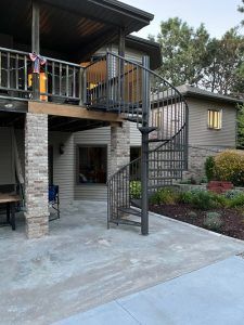 A house with a spiral staircase leading up to the second floor.