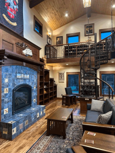 A living room with a fireplace and a spiral staircase