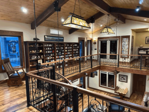 A view of a living room from the second floor of a house.