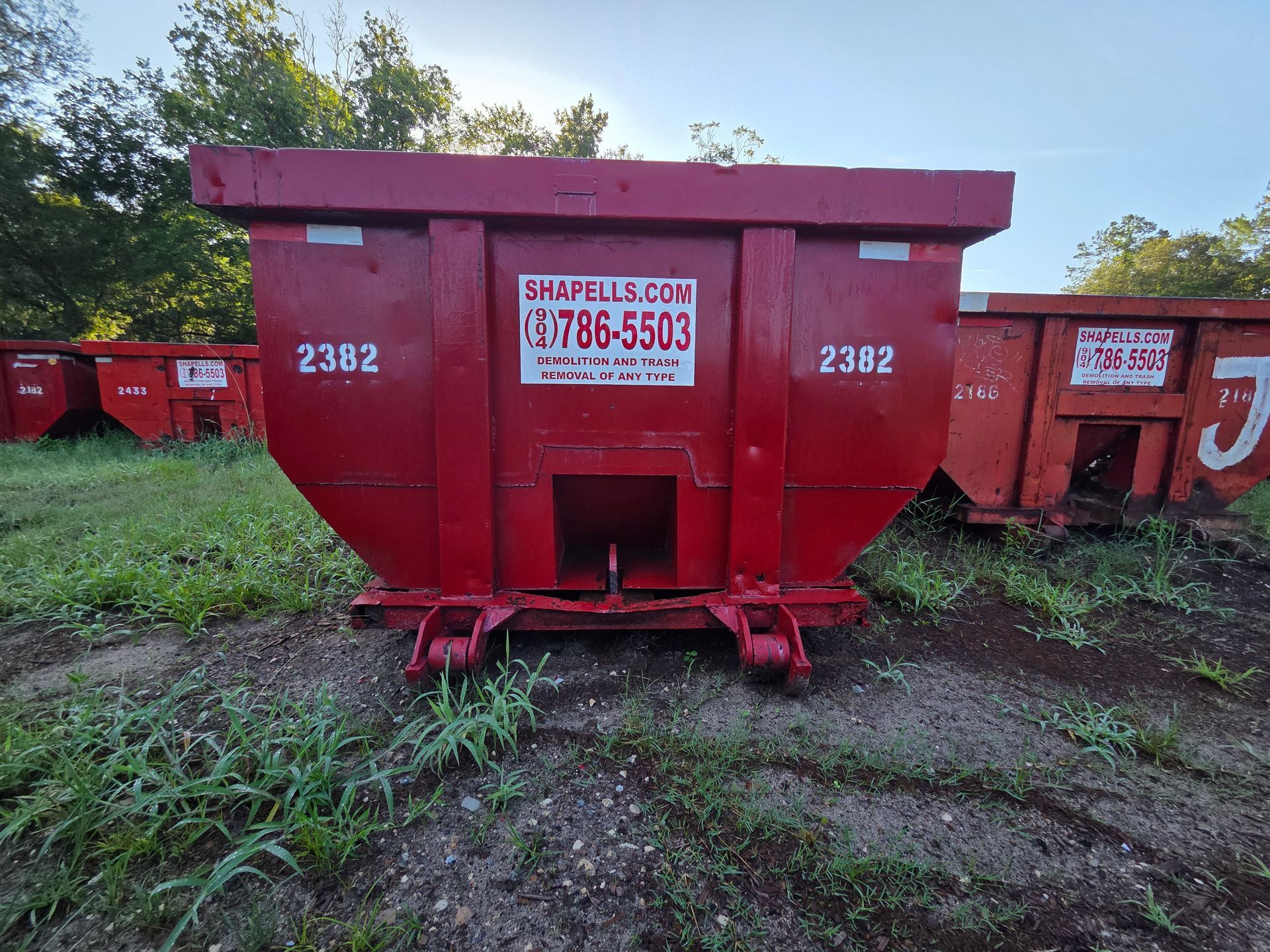 A red dumpster with the number 2302 on it