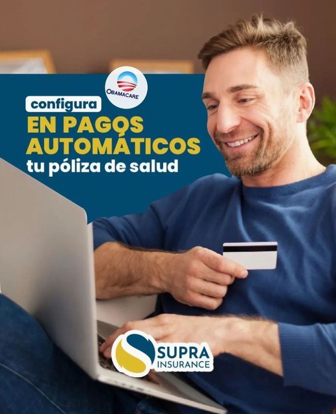 A man is holding a credit card while using a laptop computer