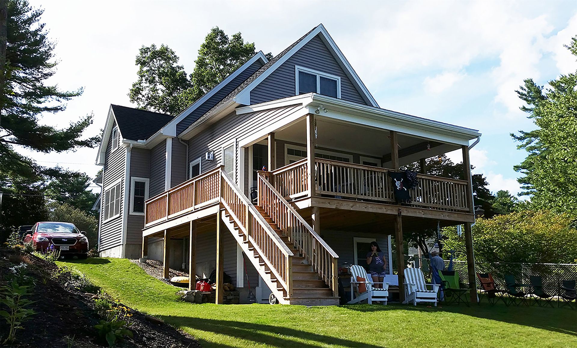 a large house with a large deck and stairs