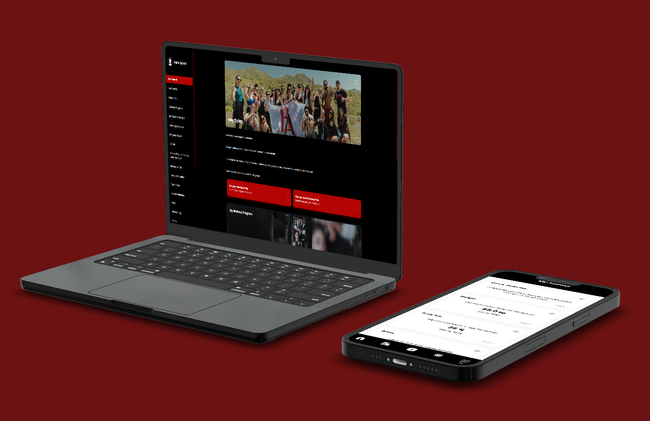 A laptop and a cell phone are sitting next to each other on a red background.
