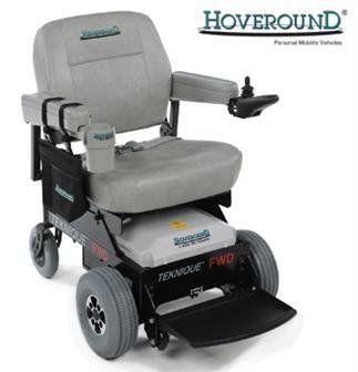Hoveround Teknique FWD power wheelchair with gray seat, black frame, and joystick controller.