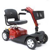 Red mobility scooter with black seat and basket, white wheels.