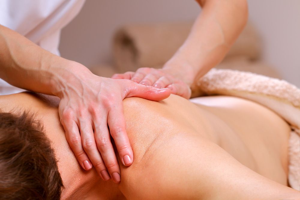A Man Is Getting A Massage At A Spa — A Myo-Therapy Approach To Remedial & Bowen Therapies In West Gladstone, QLD
