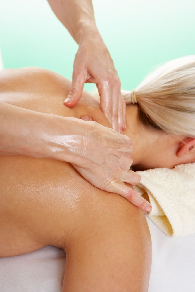 A Woman Is Getting A Massage On Her Back At A Spa — A Myo-Therapy Approach To Remedial & Bowen Therapies In West Gladstone, QLD