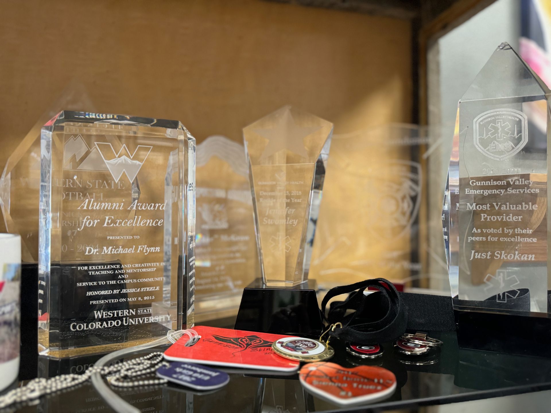 A display case filled with trophies and other items.