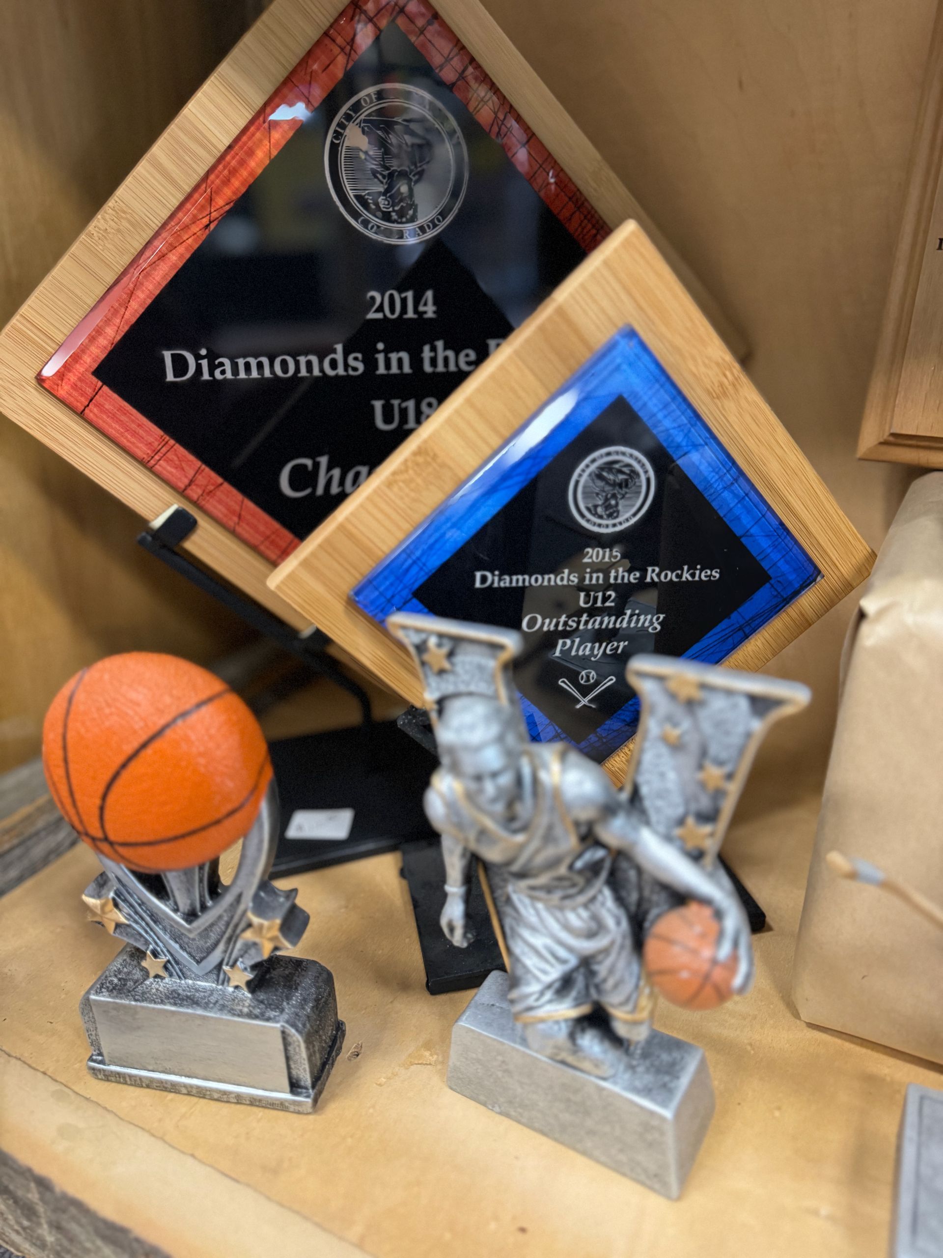 A trophy with a basketball and a plaque that says diamonds in the u18
