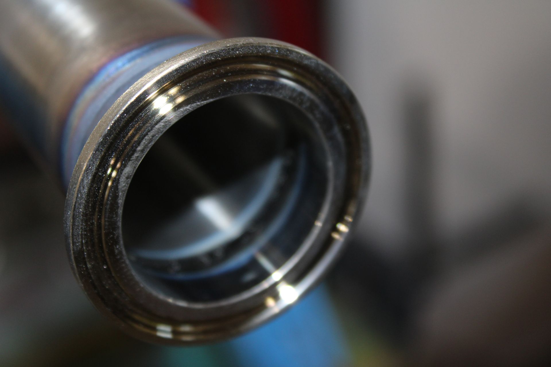A close up of a metal pipe with a flange on it.