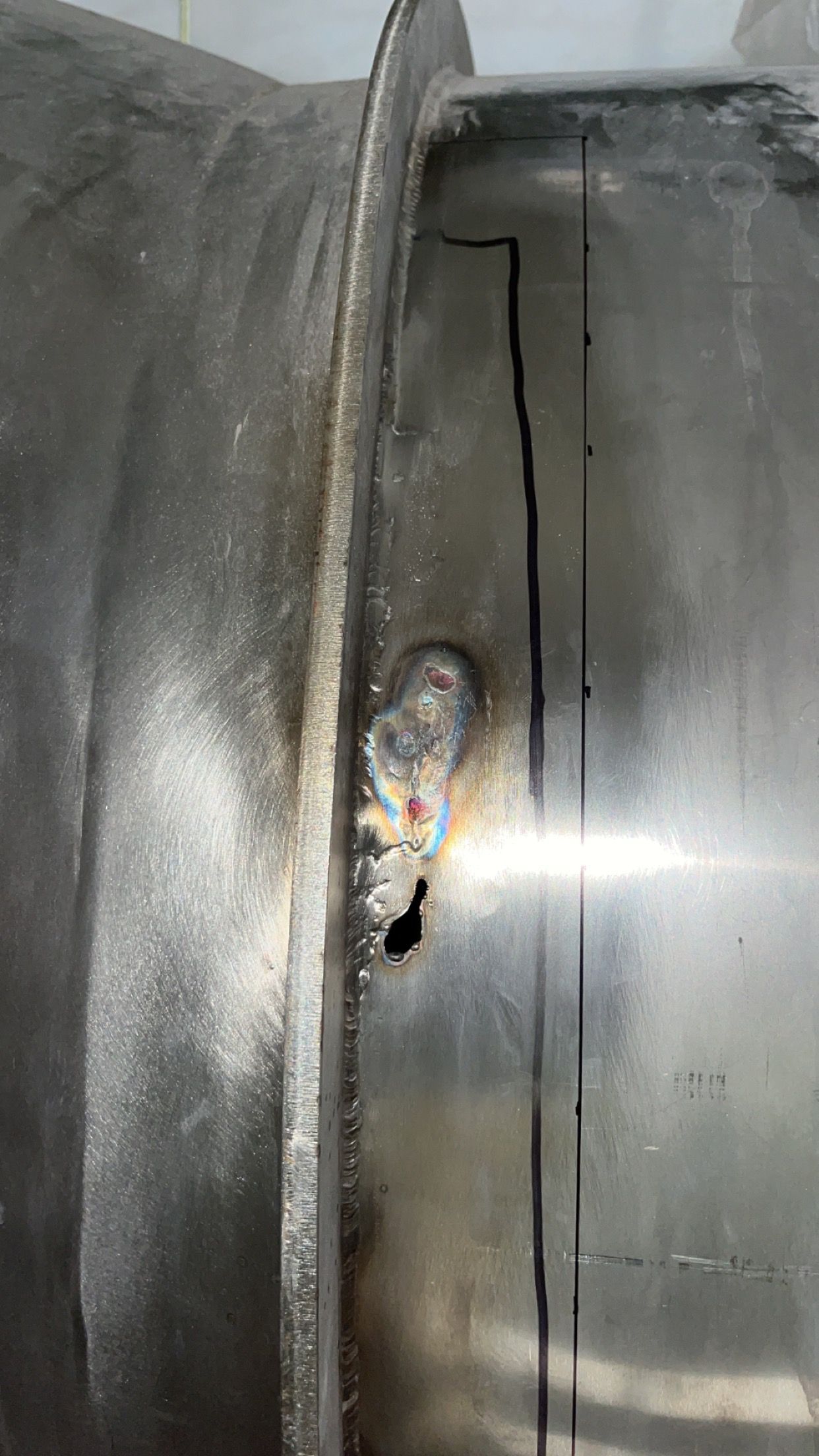 A close up of a metal pipe with a hole in it.