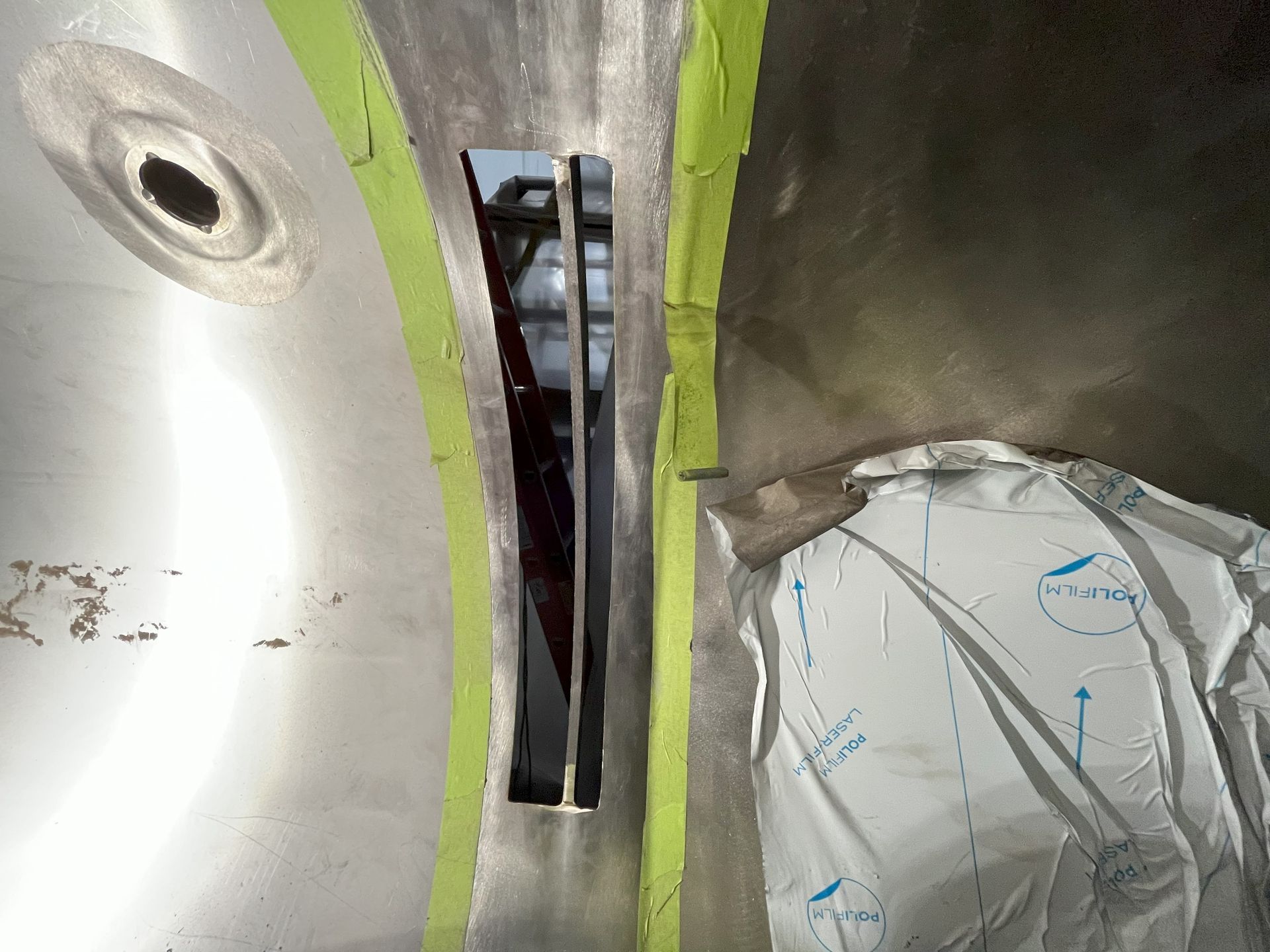 A piece of stainless steel with a hole in it