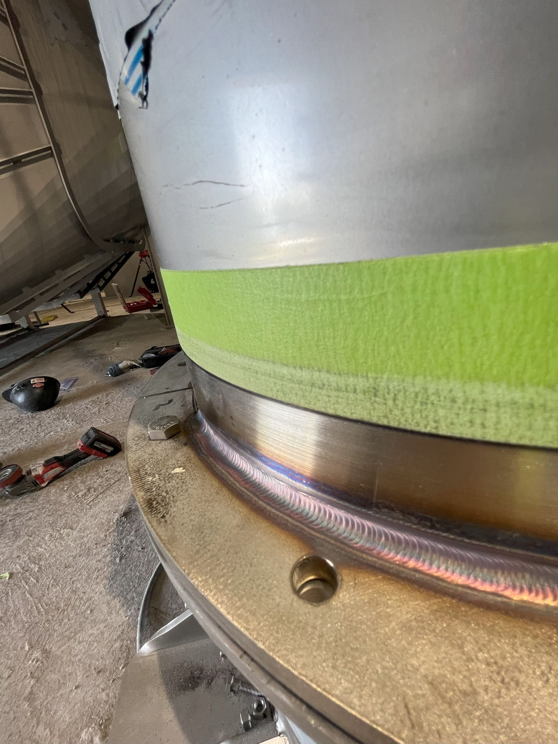 A close up of a metal object with green tape on it.