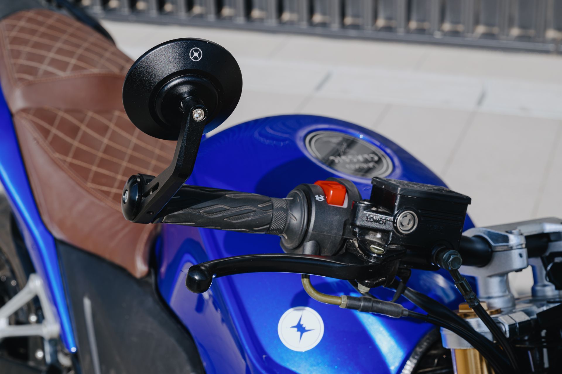 A close-up of a blue electric motorcycle with a brown seat. Urban Classic 2022 Vienna