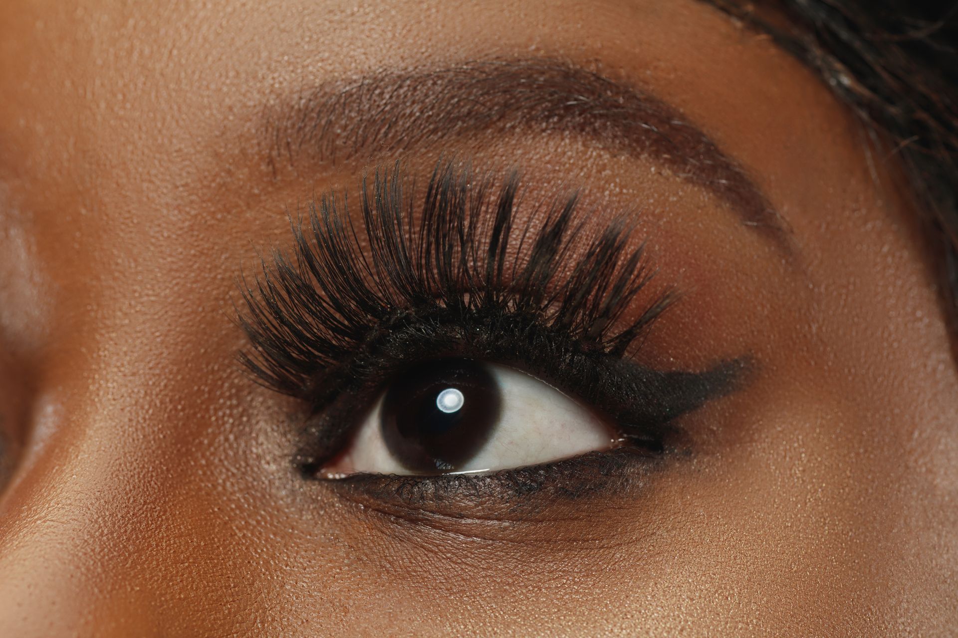 a close up of a woman 's eye with long eyelashes