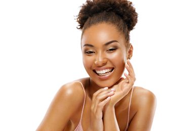 a woman with curly hair is smiling 