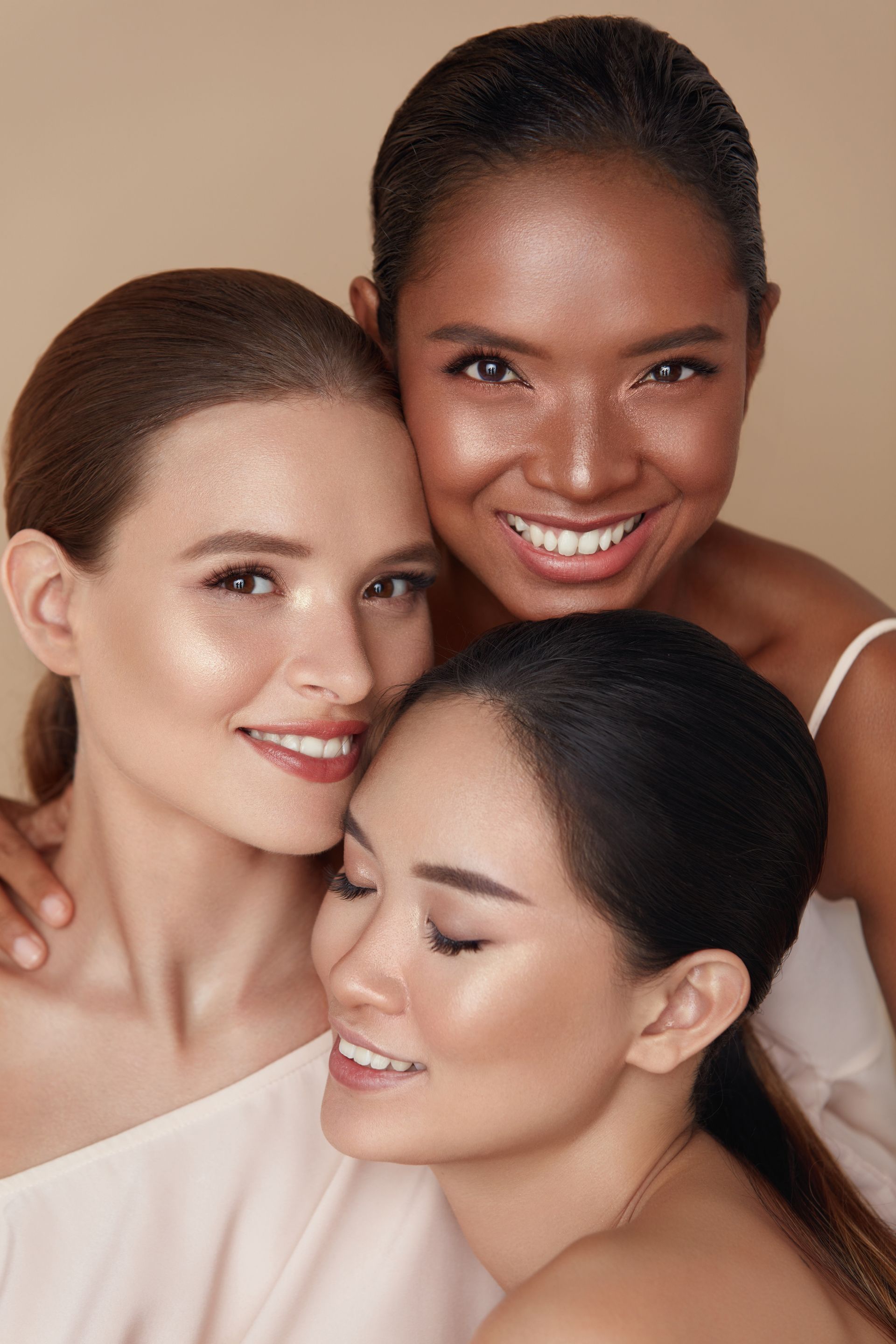 three women are posing for a picture and smiling for the camera