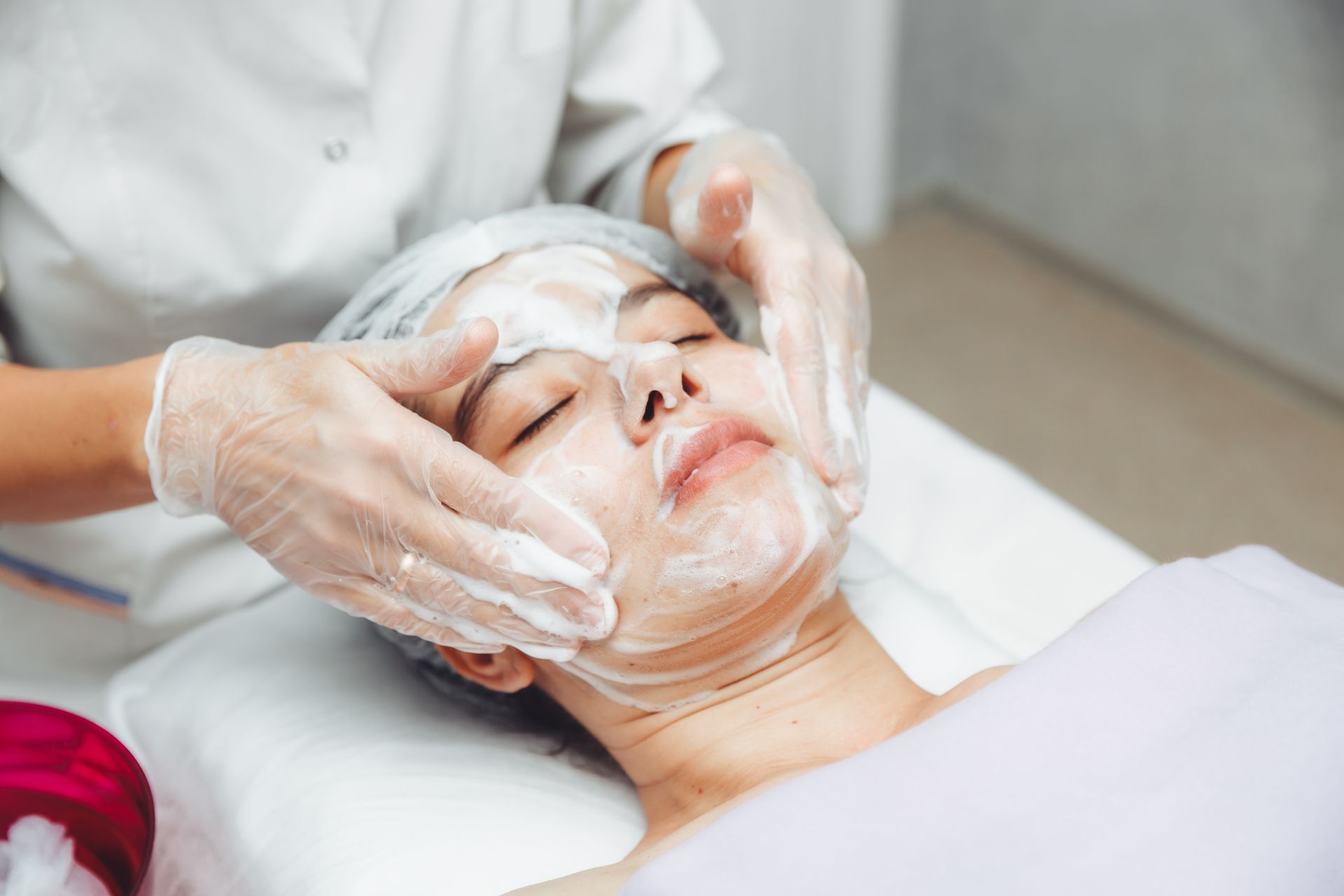 A woman is getting a facial treatment in a beauty salon.